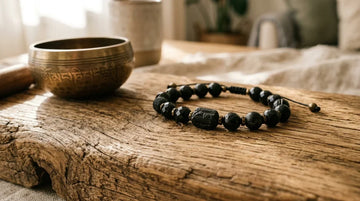 Natural black tourmaline beaded bracelet on warm wood surface for energy protection.